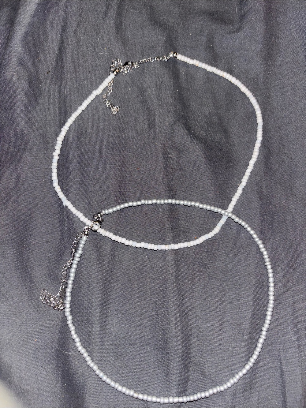 White and silver beaded necklaces.